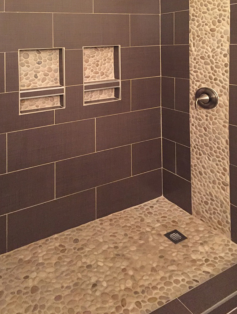 Tan Pebble Tile Shower Floor with Accents