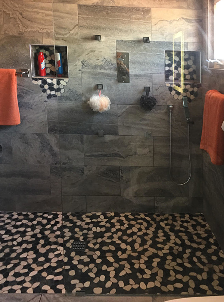 Sliced Black and White Pebble Tile Shower Floor and Niche