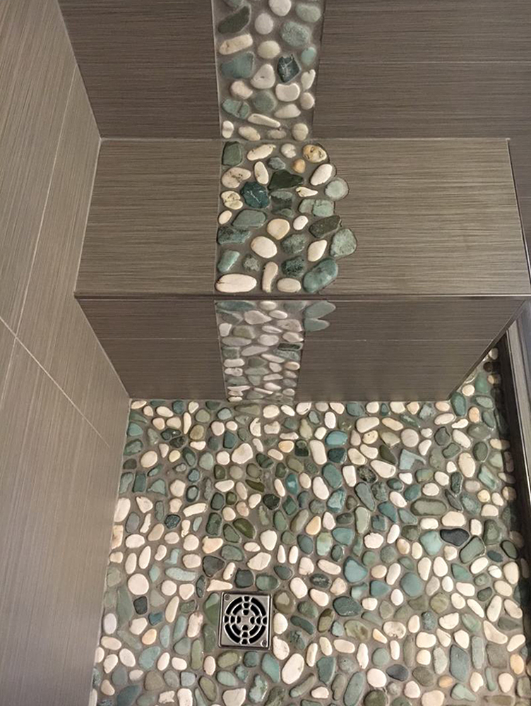 Sea Green and White Pebble Tile Shower Basin with Unique Accent Strip