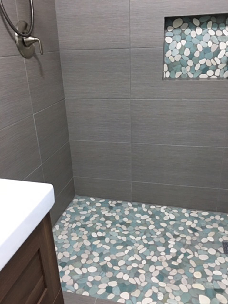 Sliced Sea Green and White Pebble Tile Shower Floor with Accent